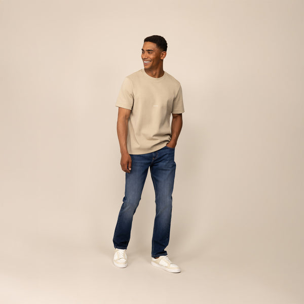 Man wearing Marame Straight Leg Denim Jeans in Navy Wash, front view.