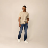 Man wearing Marame Straight Leg Denim Jeans in Navy Wash, front view.