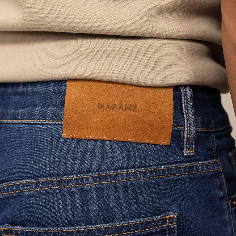 Man wearing Marame Straight Leg Denim Jeans in Navy Wash, rear view. |navy wash denim