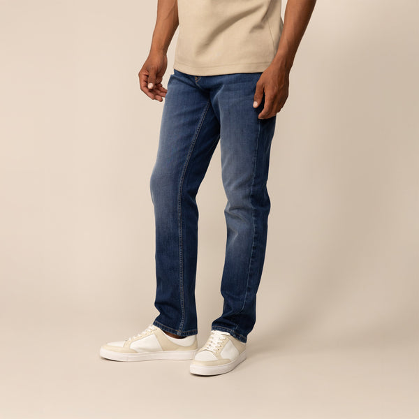 Man wearing Marame Straight Leg Denim Jeans in Navy Wash, front view.