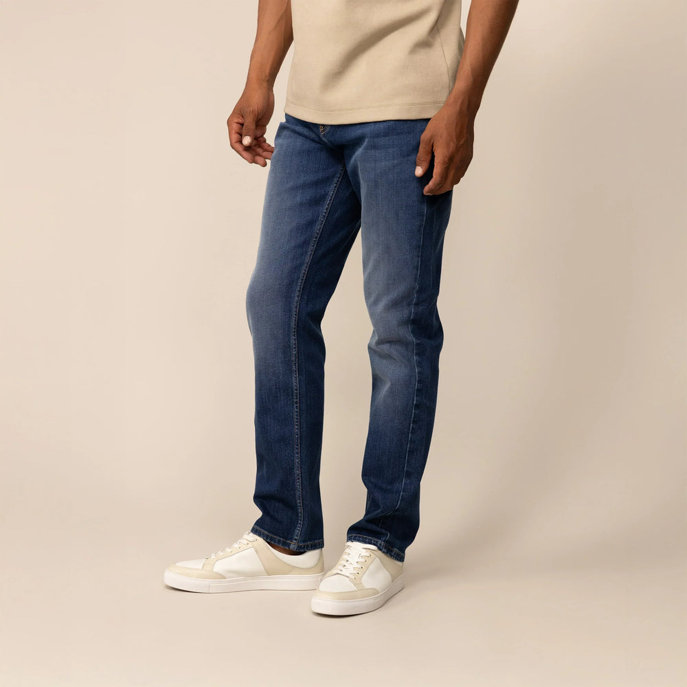 Man wearing Marame Straight Leg Denim Jeans in Navy Wash, front view.