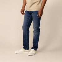 Man wearing Marame Straight Leg Denim Jeans in Navy Wash, front view.