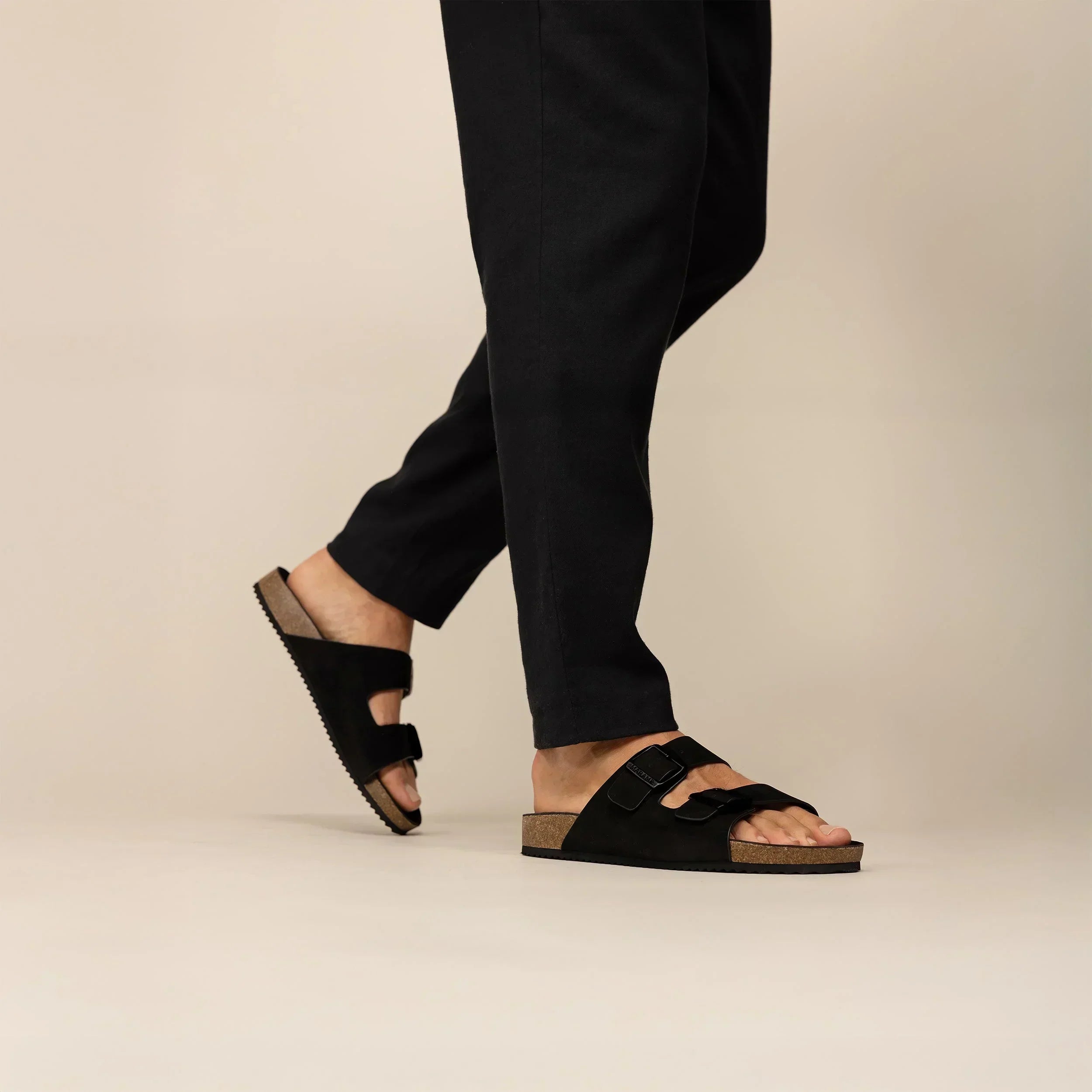 Man wearing Marame Suede Sandals in Black, front view. |black
