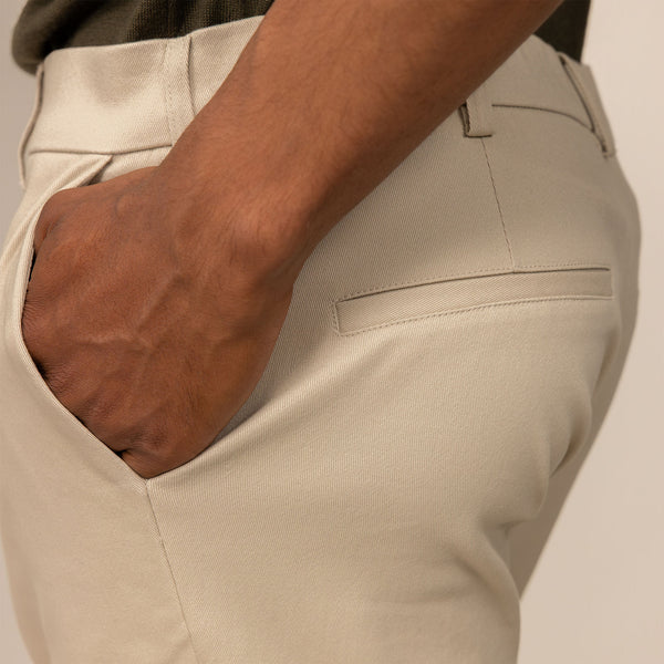 Man wearing Classic Tapered Chinos in Almond Taupe, closeup.