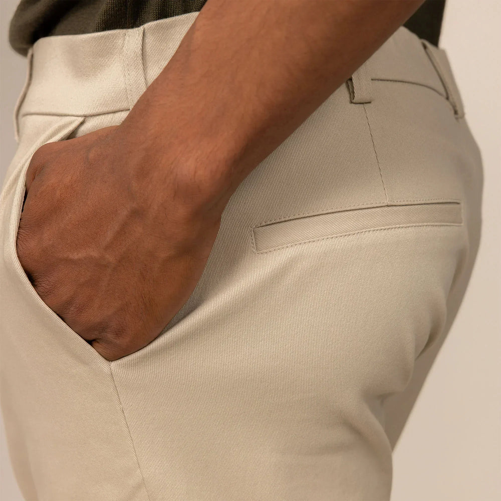 Man wearing Classic Tapered Chinos in Almond Taupe, closeup.