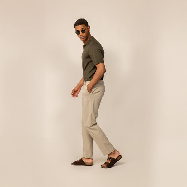 Man wearing Marame Classic Tapered Chinos in Almond Taupe, full view.