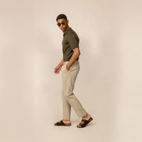Man wearing Marame Classic Tapered Chinos in Almond Taupe, full view.
