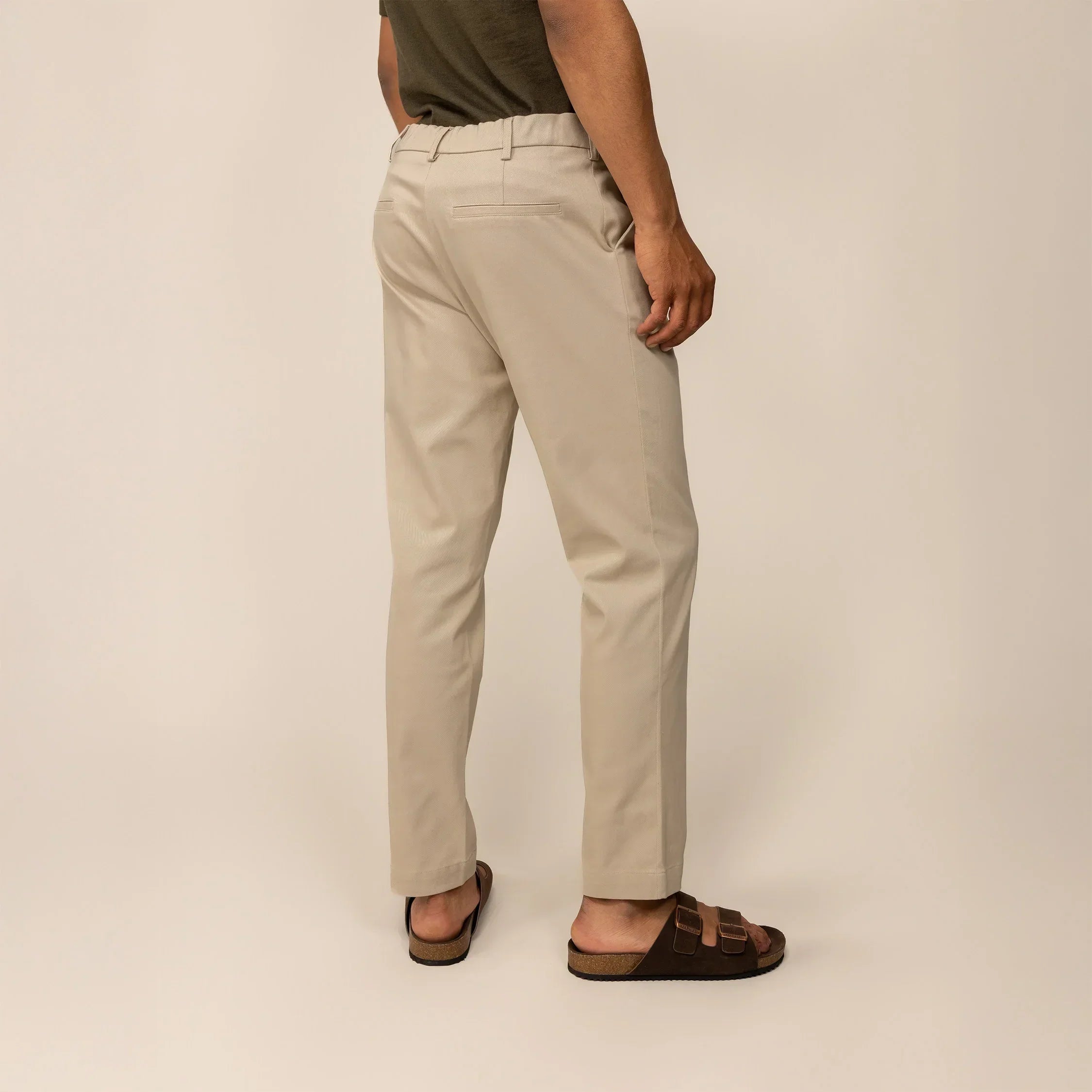 Man wearing Marame Classic Tapered Chinos in Almond Taupe, rear view | almond taupe