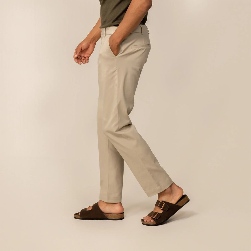 Man wearing Marame Classic Tapered Chinos in Almond Taupe, side view.