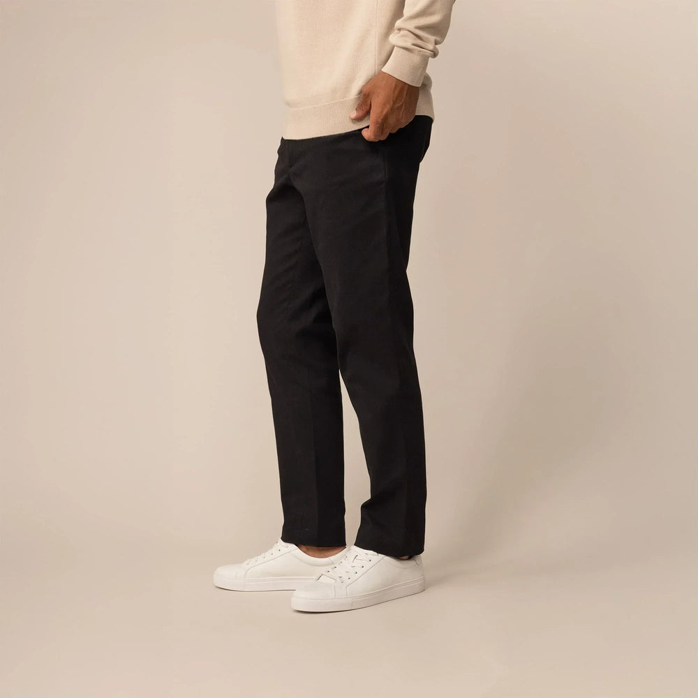 Man wearing Marame Tapered Chinos in Black, front view | black