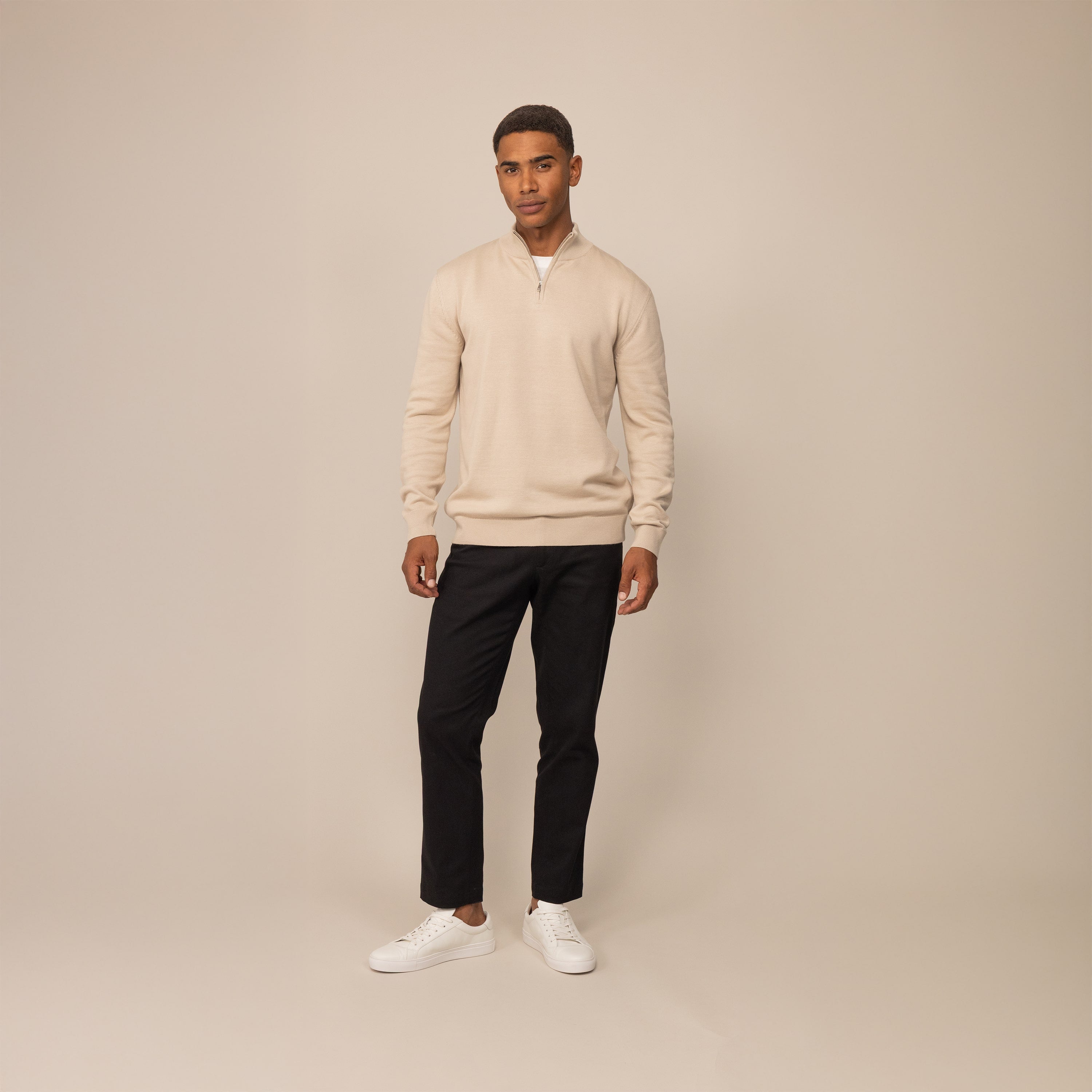 Man wearing Marame Tapered Chinos in Black, front view.