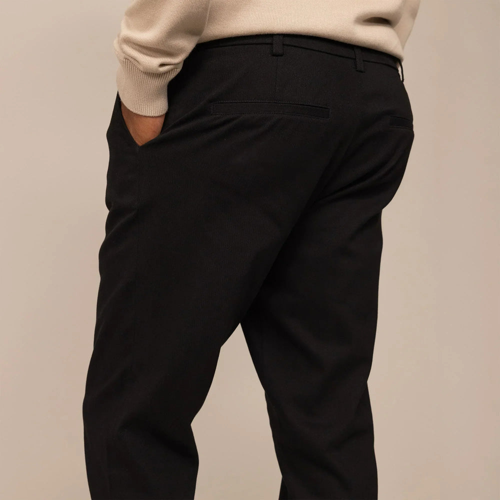 Man wearing Tapered Chinos in Black, rear view  | black