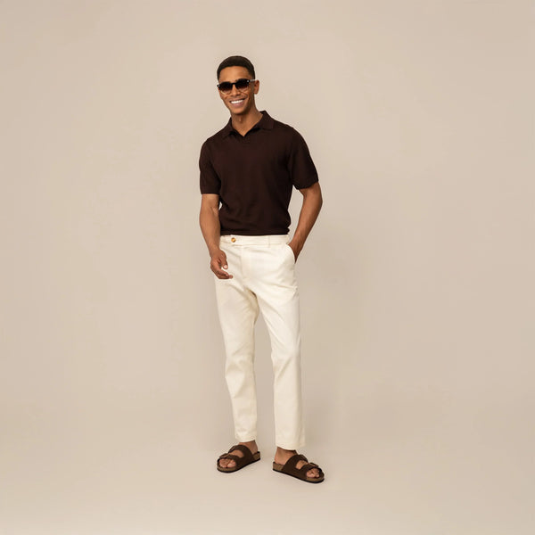 Man wearing Marame Tapered Chinos in Ivory Stone, front view.