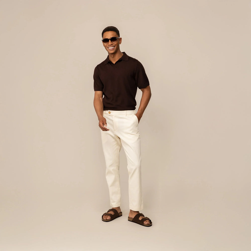 Man wearing Marame Tapered Chinos in Ivory Stone, front view.