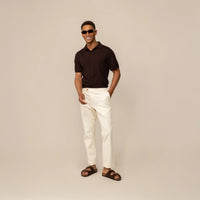 Man wearing Marame Tapered Chinos in Ivory Stone, front view.