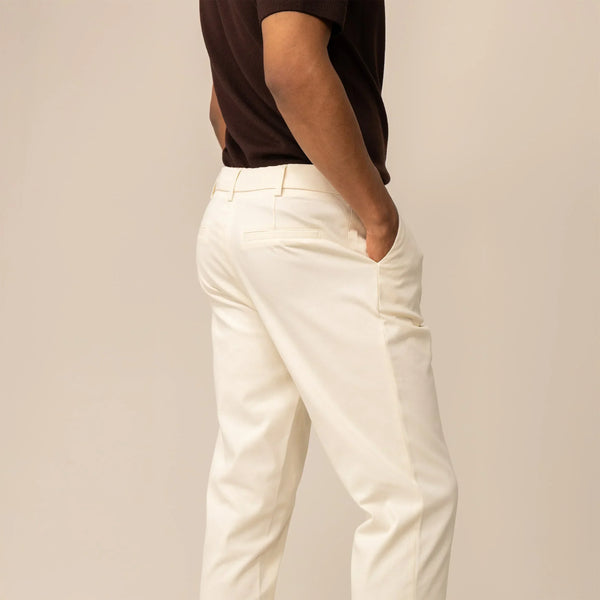 Man wearing Marame Tapered Chinos in Ivory Stone, rearview.