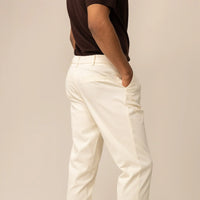Man wearing Marame Tapered Chinos in Ivory Stone, rearview.