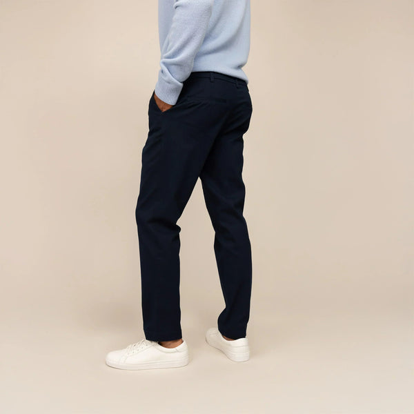 Man wearing Marame Tapered Chinos in Navy, rear view  | navy