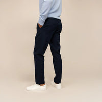 Man wearing Marame Tapered Chinos in Navy, rear view  | navy