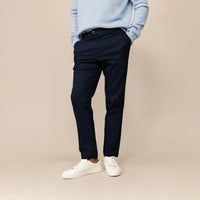 Man wearing Marame Tapered Chinos in Navy, front view.