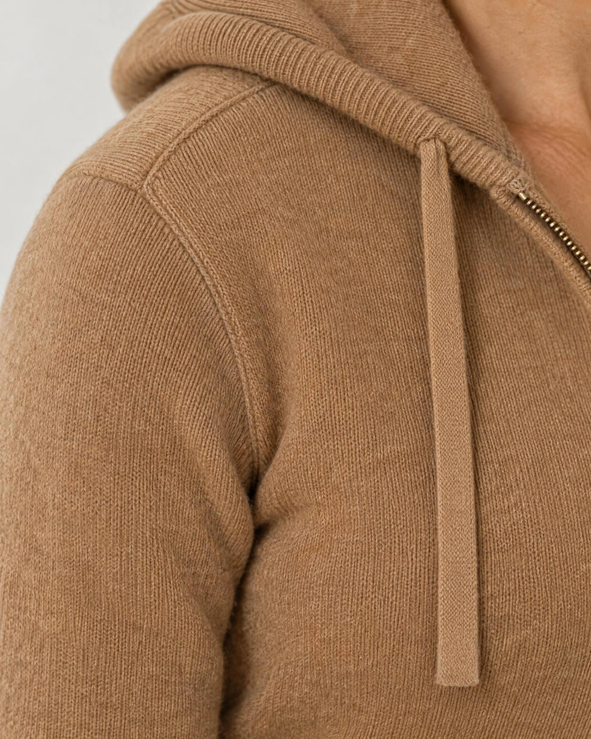 
The Noa Cashmere Blend Hooded Cardigan in Camel Beige, close-up of the shoulder seam and knit texture