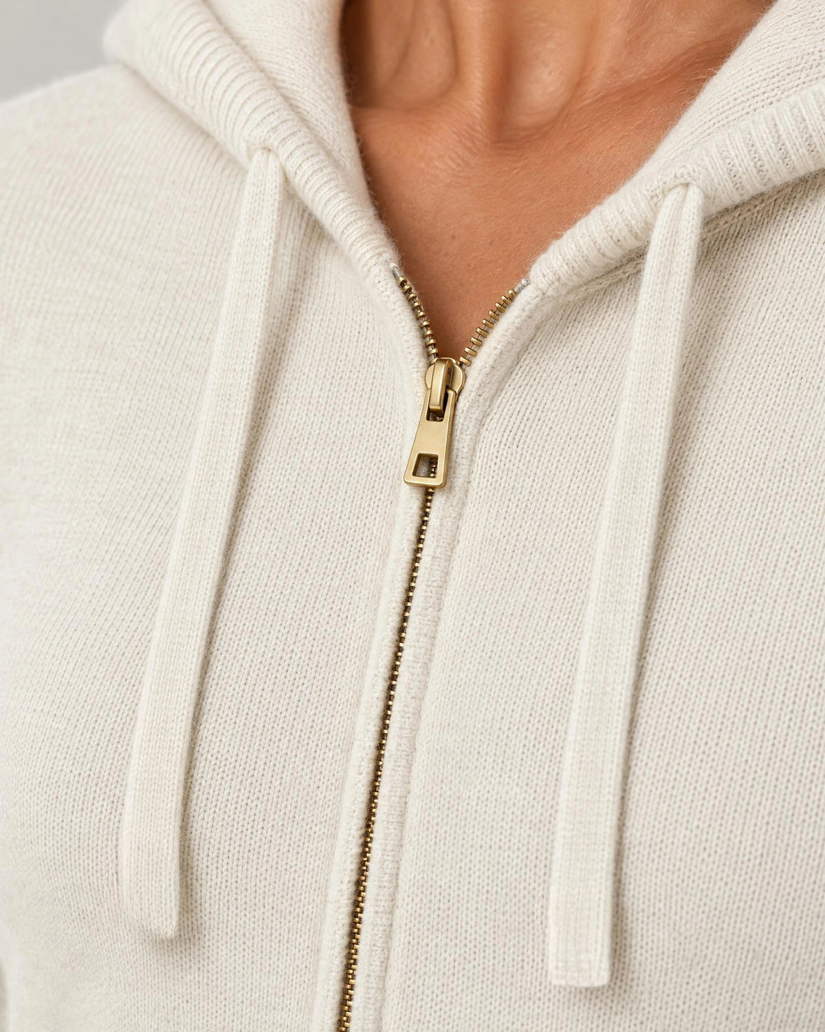 
The Noa Cashmere Blend Hooded Cardigan in Cream, close-up of the knit texture and gold-tone zip