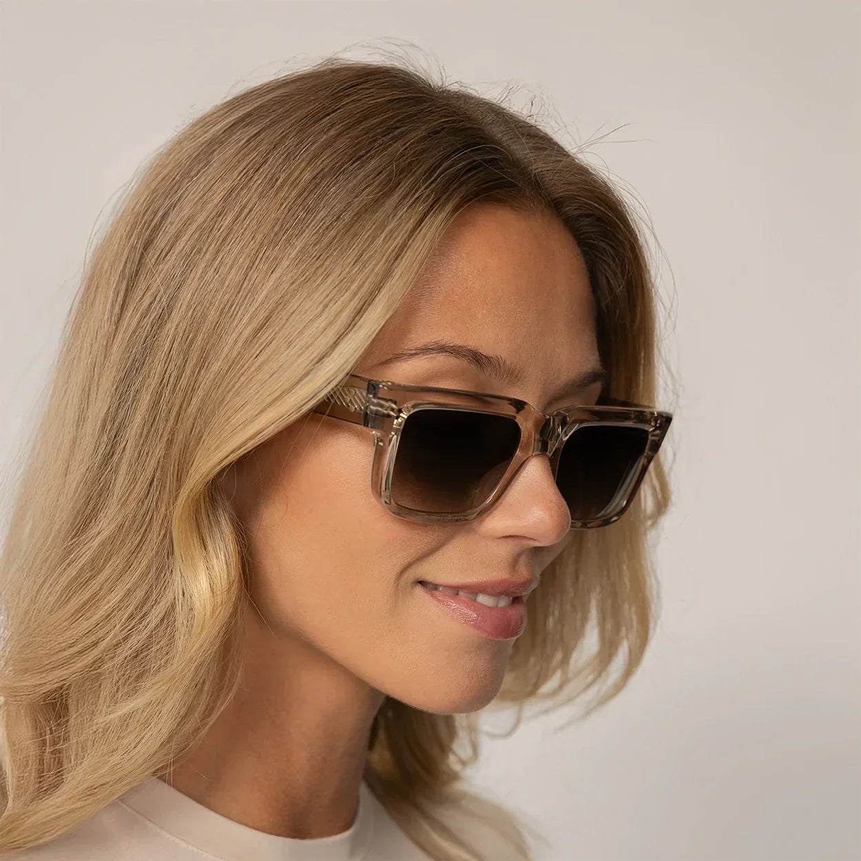 Woman wearing Cutler and Gross Square Sunglasses 1403 in Sand Crystal, front view.|sand crystal