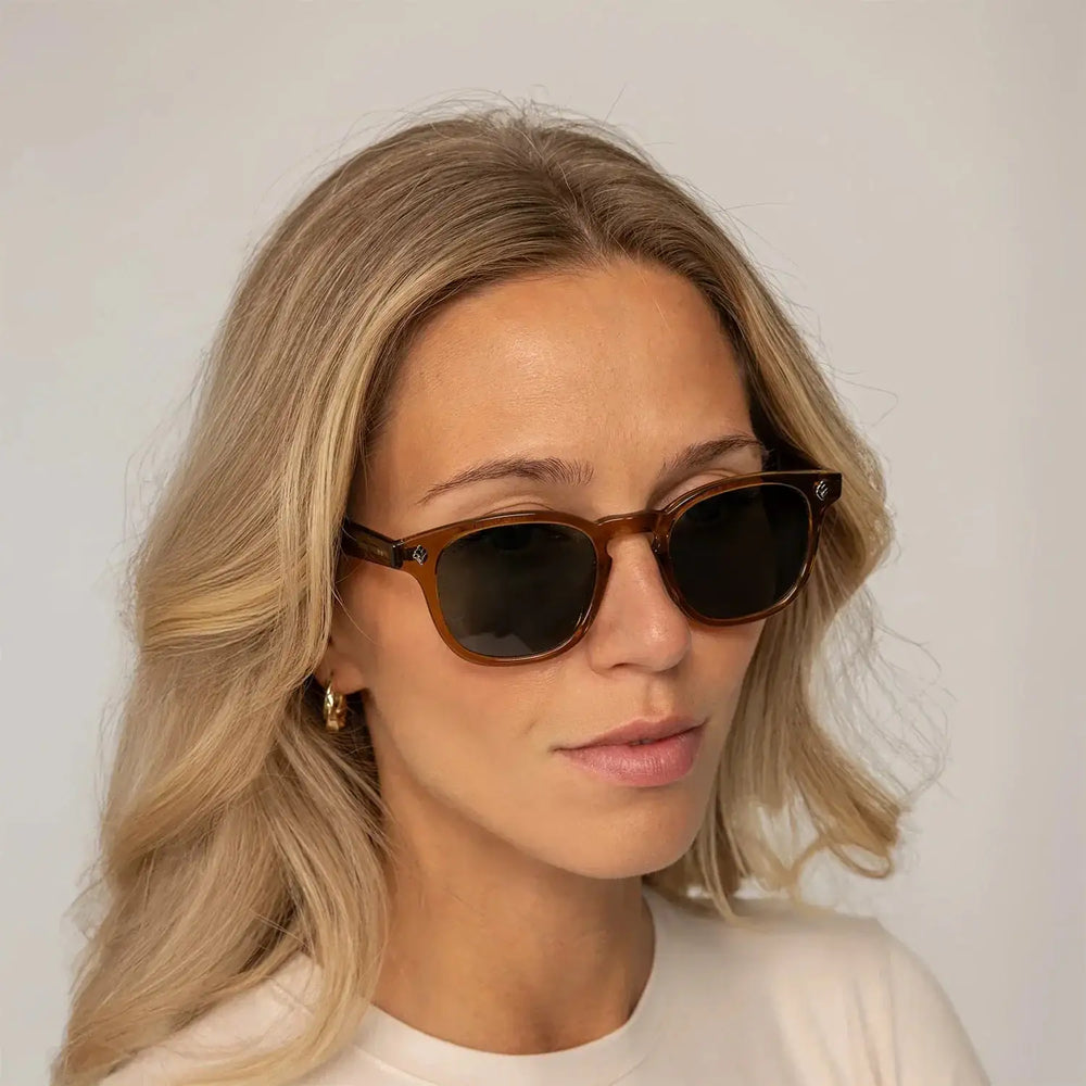 Womean wearing Garrett Leight Ace Sun Sunglasses in Caramel, front view.|caramel