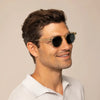 Man wearing Garrett Leight Ace Sun Sunglasses in Pure Glass, front view.|pure glass
