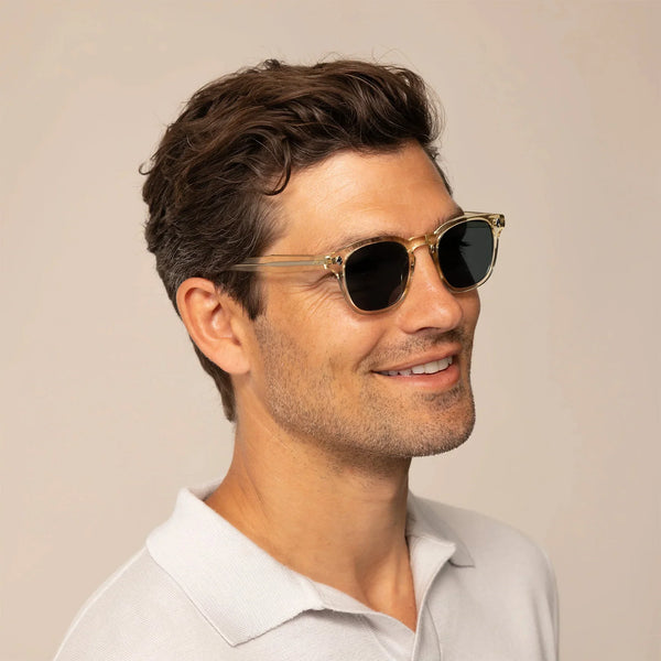 Man wearing Garrett Leight Ace Sun Sunglasses in Pure Glass, front view.