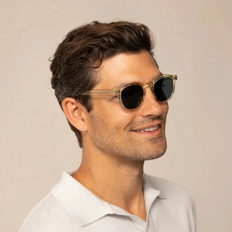 Man wearing Garrett Leight Ace Sun Sunglasses in Pure Glass, front view.|pure glass