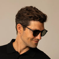 Man wearing Garrett Leight Clune Sun Sunglasses in Black, front view.