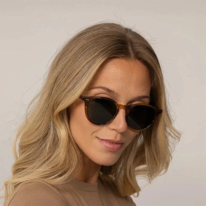 Woman wearing Garrett Leight Clune Sun Sunglasses in True Demi, front view.|true demi