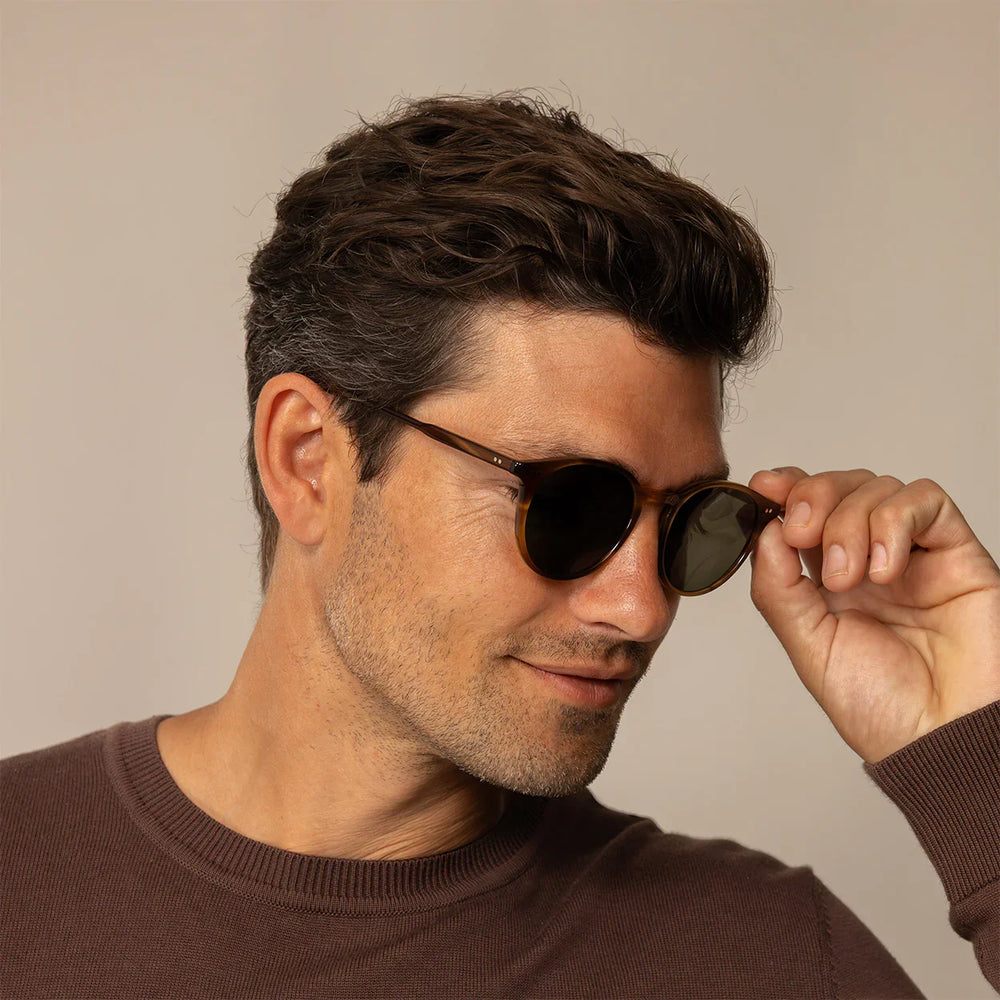 Man wearing Garrett Leight Hampton Sun Sunglasses in Olive Tortoise, front view.