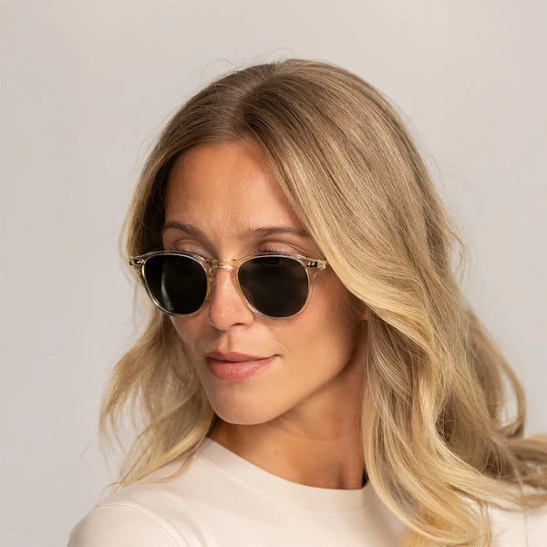 Woman wearing Garrett Leight Hampton Sun Sunglasses in Pure Glass, front view.