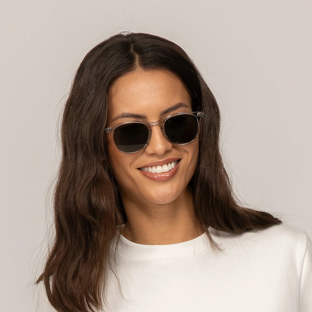 Woman wearing Garrett Leight Kinney Sun Sunglasses in Light Light Grey, front view.