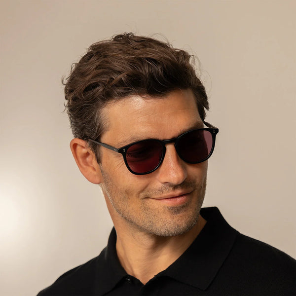 Man wearing Garrett Leight Kinney Sun Sunglasses in Matte Black, front view.