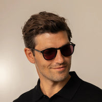 Man wearing Garrett Leight Kinney Sun Sunglasses in Matte Black, front view.