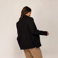 Woman wearing a Marame Classic Blazer in Black, rear view.