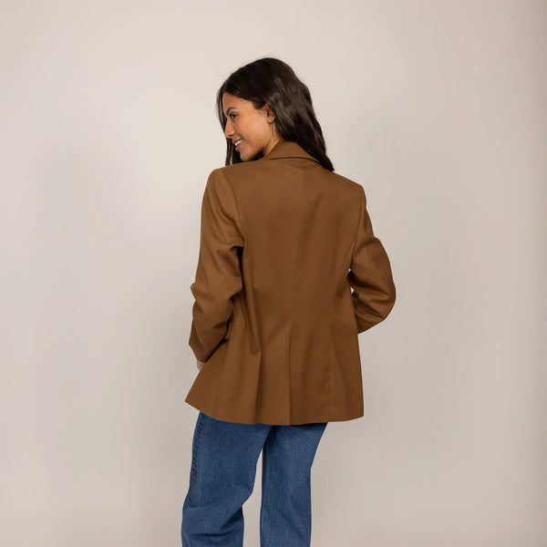 Woman wearing a Marame Classic Blazer in Brown Toffee, rear view.