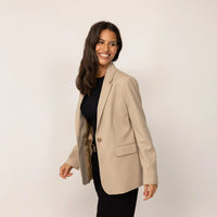 Woman wearing a Classic Blazer in Natural Beige, front view.