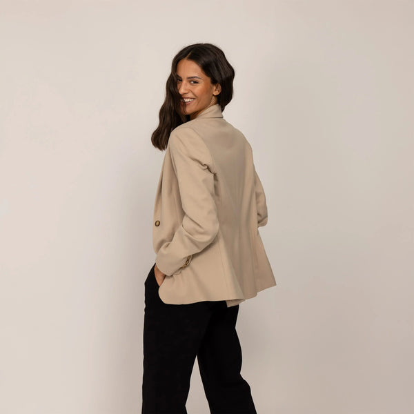 Woman wearing a Marame Classic Blazer in Natural Beige, rear view. |natural beige