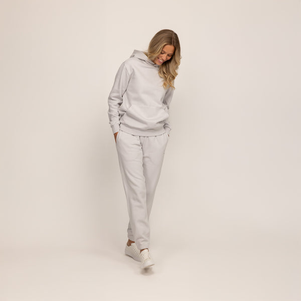 Woman wearing Marame cotton fleece hoodie in Ash White, full view.