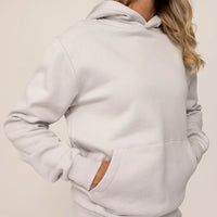 Woman wearing cotton fleece hoodie in Ash White, closeup.|ash white