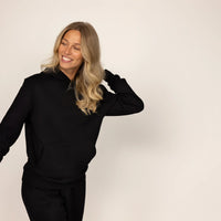 Woman wearing cotton fleece hoodie in Black.