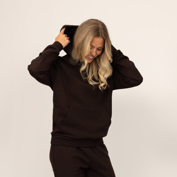 Woman wearing Marame cotton fleece hoodie in Smoked Brown.
