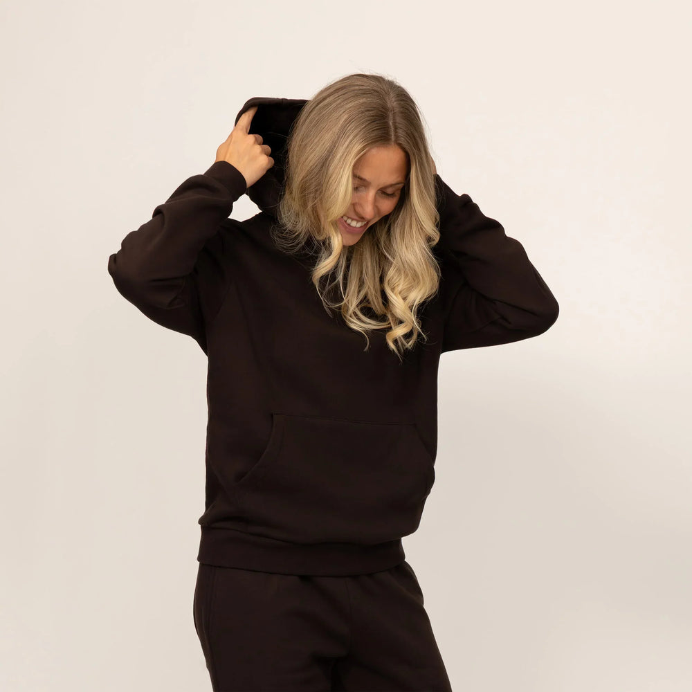 Woman wearing Marame cotton fleece hoodie in Smoked Brown.