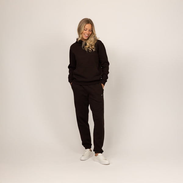 Woman wearing Marame cotton fleece hoodie in Smoked Brown, full view.