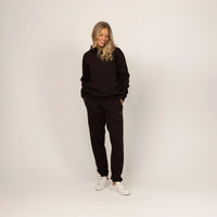 Woman wearing Marame cotton fleece hoodie in Smoked Brown, full view.