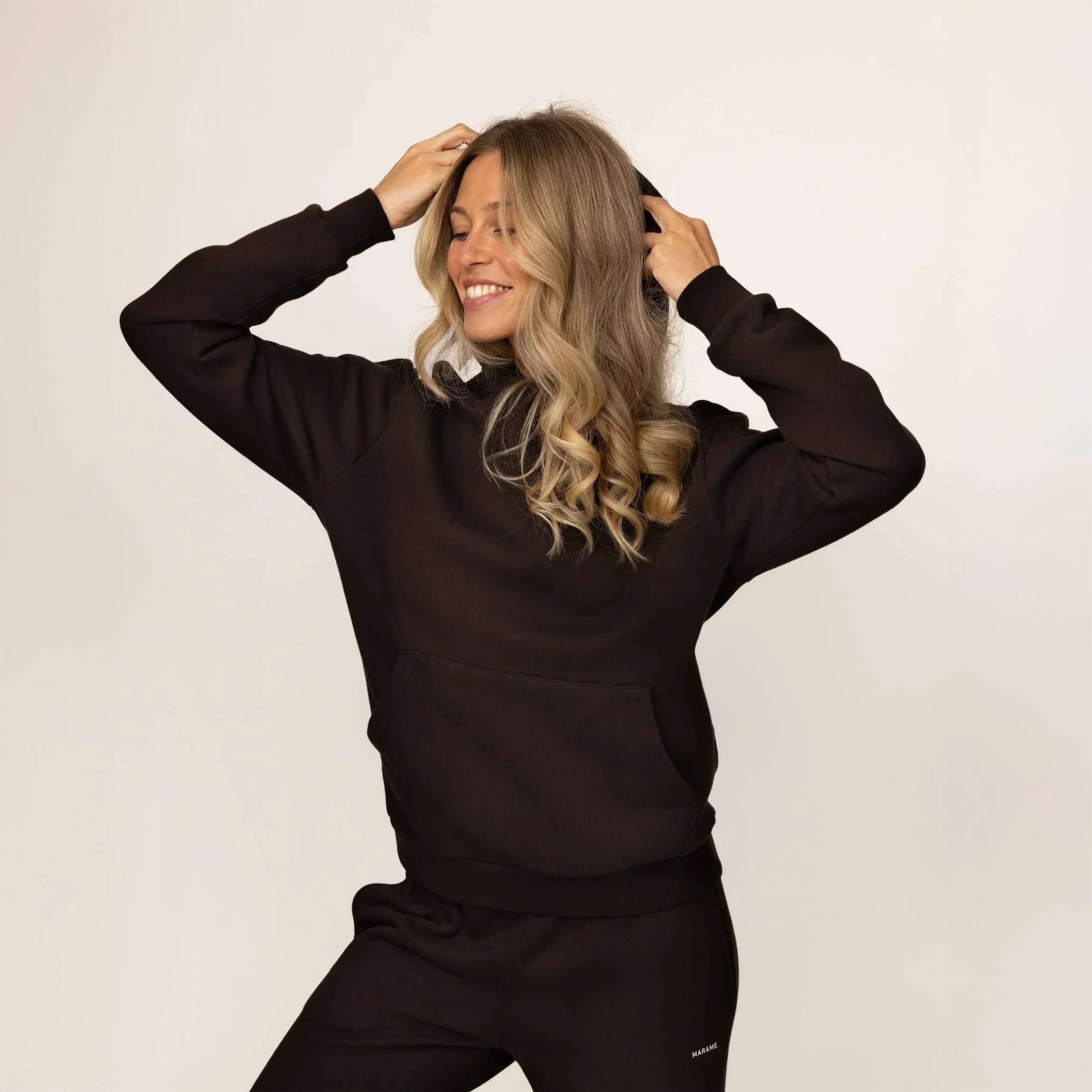 Woman wearing Marame cotton fleece hoodie in Smoked Brown, front view.|smoked brown